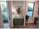 Bright entryway with a stylish green cabinet and natural light at 5980 Central Ave, New Port Richey, FL 34653