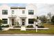 Modern white duplex with gray doors and walkway at 5980 Central Ave, New Port Richey, FL 34653