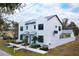 Modern two-story home with white exterior, gray roof, and two-car garage at 5980 Central Ave, New Port Richey, FL 34653