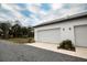 Two-car garage with white doors and modern lighting at 5980 Central Ave, New Port Richey, FL 34653