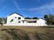 Modern house exterior with a white fence and landscaping at 5980 Central Ave, New Port Richey, FL 34653