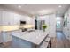 Modern kitchen with white cabinets, granite countertops, and stainless steel appliances at 5980 Central Ave, New Port Richey, FL 34653