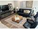 Modern living room with leather sofa and ottoman at 5980 Central Ave, New Port Richey, FL 34653