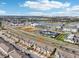 Aerial view of townhomes, nearby shopping, and a picturesque lake under a sunny, partly cloudy sky at 6324 Camino Dr, Apollo Beach, FL 33572