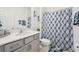 Stylish bathroom with a vanity, mirror, and a shower with a decorative curtain at 6324 Camino Dr, Apollo Beach, FL 33572
