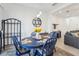Cozy dining area with blue table set and decorative sunflowers, adjacent to open-concept living space at 6324 Camino Dr, Apollo Beach, FL 33572