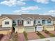 Charming townhome exteriors featuring brick-paved driveways and colorful facade at 6324 Camino Dr, Apollo Beach, FL 33572