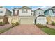 Charming multi-colored townhouses with brick paved driveway and two car garages at 6324 Camino Dr, Apollo Beach, FL 33572
