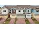 Townhome exteriors with brick driveways, garages, and colorful exteriors at 6324 Camino Dr, Apollo Beach, FL 33572