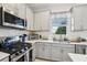 Modern kitchen with stainless steel appliances, subway tile backsplash, and ample natural light at 6324 Camino Dr, Apollo Beach, FL 33572