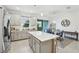 Contemporary kitchen featuring a center island, modern appliances, and seamless access to the dining space at 6324 Camino Dr, Apollo Beach, FL 33572