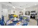 Bright open-concept kitchen featuring stainless steel appliances, island with seating, and adjacent living area at 6324 Camino Dr, Apollo Beach, FL 33572