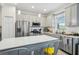 Spacious kitchen featuring stainless steel appliances, ample cabinet space, and center island with seating at 6324 Camino Dr, Apollo Beach, FL 33572