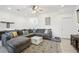 Cozy living room with a sectional sofa, stylish rug, and an open layout design at 6324 Camino Dr, Apollo Beach, FL 33572