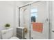 A main bathroom featuring a glass shower enclosure, a rainfall shower head, and a shower bench at 6324 Camino Dr, Apollo Beach, FL 33572