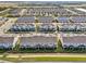 Aerial view of a neatly planned neighborhood with modern homes, manicured lawns, and organized street layout at 6324 Camino Dr, Apollo Beach, FL 33572
