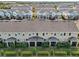 An aerial view features charming townhomes with well-maintained lawns and inviting screened patios at 6324 Camino Dr, Apollo Beach, FL 33572
