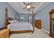 Spacious bedroom with a post bed, dresser, and ceiling fan at 727 Winterside Dr, Apollo Beach, FL 33572