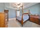 Bright bedroom featuring a post bed and ample wood furniture at 727 Winterside Dr, Apollo Beach, FL 33572