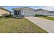 One-story home with a two-car garage and a well-maintained lawn at 727 Winterside Dr, Apollo Beach, FL 33572