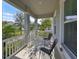 Covered porch with white railings and two black chairs at 727 Winterside Dr, Apollo Beach, FL 33572