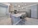 Kitchen island with seating, gray cabinets and white quartz countertops at 727 Winterside Dr, Apollo Beach, FL 33572