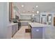 Modern kitchen with gray cabinets, quartz countertops, and island at 727 Winterside Dr, Apollo Beach, FL 33572