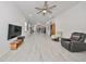 Spacious living room with ceiling fan and a view into the kitchen at 727 Winterside Dr, Apollo Beach, FL 33572