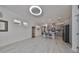 Open living room with light wood-look floors and a view of the kitchen at 727 Winterside Dr, Apollo Beach, FL 33572