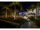 Night view of a home's backyard with pool, fire pit, and palm trees at 751 34Th Ne Ave, St Petersburg, FL 33704