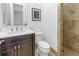 Stylish bathroom with dark wood vanity and a walk-in shower at 751 34Th Ne Ave, St Petersburg, FL 33704