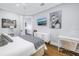 Bright bedroom with a comfortable bed, built-in desk, and hardwood floors at 751 34Th Ne Ave, St Petersburg, FL 33704