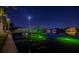 Night view of a boat dock with green lighting on the water at 751 34Th Ne Ave, St Petersburg, FL 33704