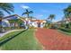 Mediterranean-style home with red brick driveway and palm trees at 751 34Th Ne Ave, St Petersburg, FL 33704