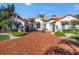 White stucco home with terracotta tile roof, brick driveway, and palm trees at 751 34Th Ne Ave, St Petersburg, FL 33704
