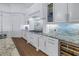 Modern kitchen featuring white cabinets, granite countertops, and a wine cooler at 751 34Th Ne Ave, St Petersburg, FL 33704