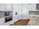 White kitchen with stainless steel appliances and ample cabinet space at 751 34Th Ne Ave, St Petersburg, FL 33704