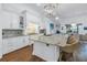 Eat-in kitchen with island seating, white cabinetry, and granite countertops at 751 34Th Ne Ave, St Petersburg, FL 33704