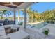 Covered patio with seating area, overlooking a refreshing pool and lush landscaping at 751 34Th Ne Ave, St Petersburg, FL 33704