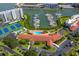 Aerial view of community pool, tennis courts, and marina at 8001 Sailboat Key S Blvd # 202, St Pete Beach, FL 33707