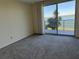 Spacious bedroom with water views and sliding glass doors to balcony at 8001 Sailboat Key S Blvd # 202, St Pete Beach, FL 33707