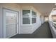 Building hallway with carpeted floors and neutral walls at 8001 Sailboat Key S Blvd # 202, St Pete Beach, FL 33707