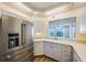 Kitchen with stainless steel appliances and white cabinetry at 8001 Sailboat Key S Blvd # 202, St Pete Beach, FL 33707