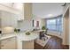 Bright living area featuring a cozy workspace, modern desk, and stylish decor near the kitchen at 8001 Sailboat Key S Blvd # 202, St Pete Beach, FL 33707
