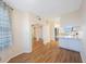 Open living area with wood-look floors and access to kitchen at 8001 Sailboat Key S Blvd # 202, St Pete Beach, FL 33707
