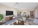Living room with staged furniture and large TV at 8001 Sailboat Key S Blvd # 202, St Pete Beach, FL 33707