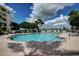 Community pool with lounge chairs and surrounding landscaping at 8001 Sailboat Key S Blvd # 202, St Pete Beach, FL 33707