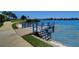 Private waterfront deck with steps leading to the water at 8001 Sailboat Key S Blvd # 202, St Pete Beach, FL 33707