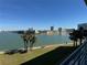 Stunning view of the waterfront with palm trees and walking path at 8001 Sailboat Key S Blvd # 202, St Pete Beach, FL 33707