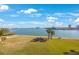 Scenic waterfront view with palm trees and lush green grass at 8001 Sailboat Key S Blvd # 202, St Pete Beach, FL 33707